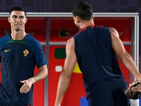 Portugal's forward Cristiano Ronaldo (left) attends a training session at the Al Shahaniya SC training site, ahead of the match against Switzerland.