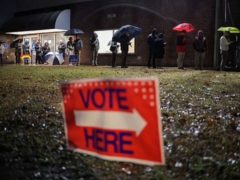 Local residents wait in line to cast their ballot during the runoff US Senate election between Democratic Senator Raphael Warnock and his Republican challenger Herschel Walker in Atlanta, Georgia, U.S., December 6, 2022.