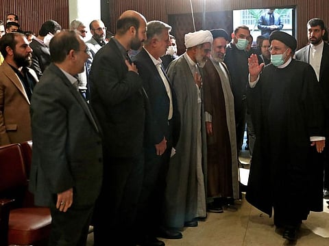 This handout picture provided by the Iranian presidency shows Iran's President Ebrahim Raisi greeting people at Tehran University during Student's Day celebrations, on December 7, 2022.