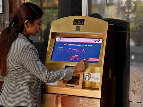 Syeda Fatima Taruj, director of Goldsikka, shows how to use India's first "gold ATM," delivering gold coins, in the southern city of Hyderabad, India, December 5, 2022.