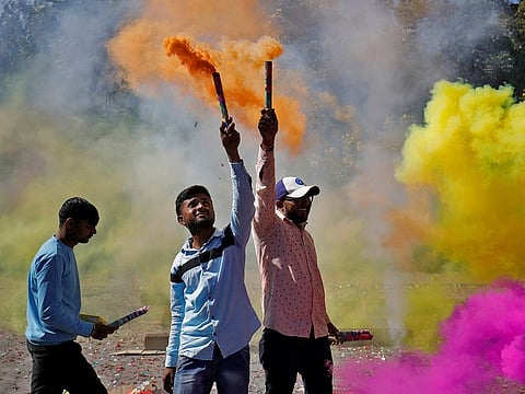 Supporters of India's ruling Bharatiya Janata Party (BJP) burn firecrackers to celebrate poll results of Gujarat state assembly election in Gandhinagar, India, December 8, 2022.