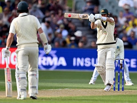 Australia's Marnus Labuschagne (right) plays a hooks as teammate Travis Head watches on during the first day of the second Test in Adelaide match between Australia and the West Indies at the Adelaide Oval in Adelaide on December 8, 2022. (Photo by William WEST / AFP) / --IMAGE RESTRICTED TO EDITORIAL USE - NO COMMERCIAL USE--