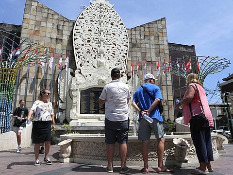Foreign tourists visit the Bali Bombing Memorial Monument in Kuta, Bali, Indonesia on Thursday, Dec. 8, 2022.