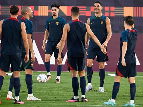 Portugal's forward Cristiano Ronaldo (second from right) and his teammates take part in a training session at the Al Shahaniya SC training site.