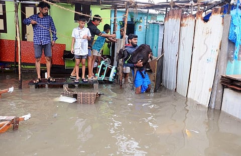 The area surrounding the settlements of Srinivasapuram community gets flooded due to heavy rains triggered by Cyclone Mandous, in Chennai on Friday.