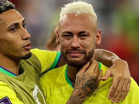 Brazil's forward Neymar (right) in tears while Raphinha consoles him after the loss in penalties against Croatia in the quarter-finals.