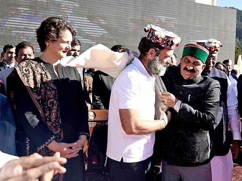 Himachal Pradesh CM Sukhwinder Singh Sukhu felicitates Congress leader Rahul Gandhi with a shawl during his oath-taking ceremony, as party General Secretary Priyanka Gandhi Vadra looks on, in Shimla on Sunday, Dec 11, 2022.