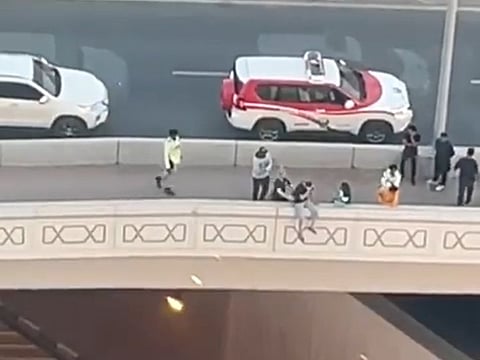 Still from police video showing moment the man was pulled back from the brink