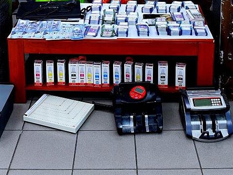 Police seized the fake cash and equipment used in counterfeiting