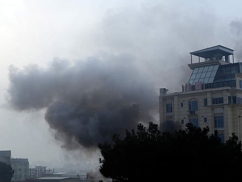 Smoke rises from a hotel building after explosions and gunfire in the city of Kabul, Afghanistan, Monday, Dec. 12, 2022.