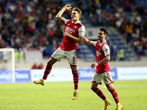 Arsenal's Martin Odegaard (left) celebrates scoring the first goal with Fabio Vieira against AC Milan in the Dubai Super Cup match at Al Maktoum Stadium, Dubai, UAE.