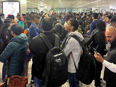 Passengers wait in queue to board flights at the Indira Gandhi International Airport, New Delhi, Dec 13, 2022.