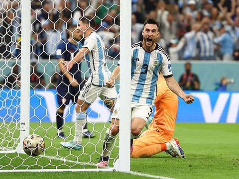 Argentina's Nicolas Tagliafico celebrates after Julian Alvarez scores their third goal