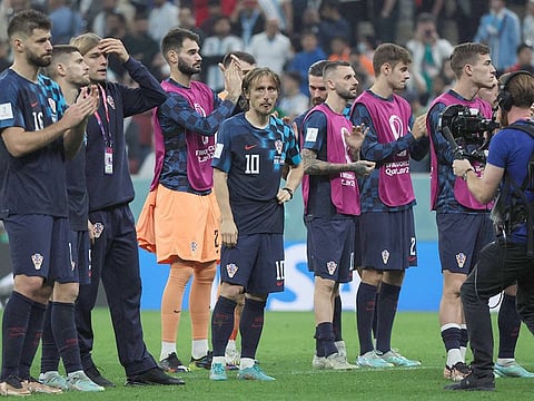 Croatia's midfielder Luka Modric (C) looks dejected after his team lost the Qatar World Cup football semi-final match against Argentina at Lusail Stadium in Lusail, north of Doha on December 13, 2022.