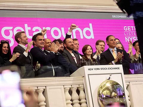 Sam Zaid, Elliot Kroo, and Jessica Scorpio, founders of Getaround, ring the opening bell, to celebrate their company's listing at the New York Stock Exchange (NYSE) in New York City, U.S., December 9, 2022.