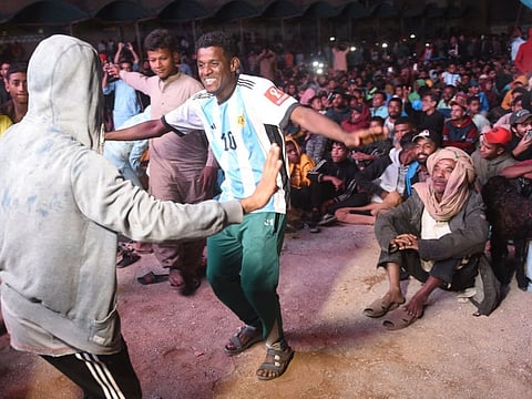 Pakistani football fans dance as they watch the live broadcast of the Qatar 2022 World Cup football semi-final match between Argentina and Croatia in the Lyari neighbourhood of Karachi on December 14, 2022.
