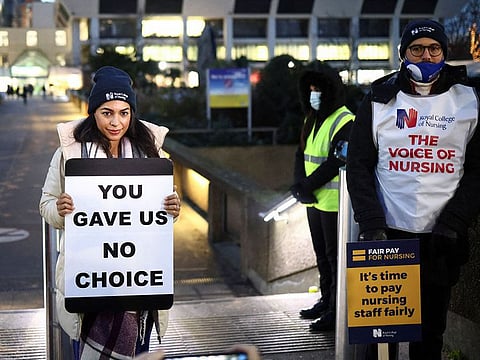Nurses hold signs during a strike outside St Thomas' Hospital in London, Britain. This week nurses in England, Wales and Northern Ireland were also due to resume strike action on Wednesday and Thursday.