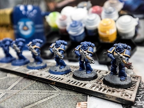 FILE PHOTO: FILE PHOTO: Figures sit on display at a Warhammer store, a brand owned by Games Workshop, in London, Britain, November 17, 2021. Picture taken November 17, 2021. REUTERS/May James/File Photo/File Photo