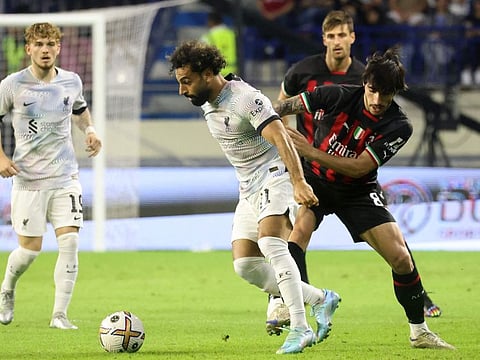 AC Milan's Italian midfielder Sandro Tonali (right) marks Liverpool's Egyptian striker Mohamed Salah during the Dubai Super Cup 2022 match at Al Maktoum Stadium, Dubai. Liverpool won 4-1