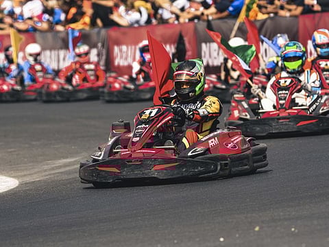 Duarte Lopez of Dojomoto carrying the UAE flag after winning the Dubai Kartdrome 24 Hours endurance race.