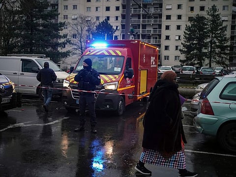 A firefighter truck next to apartment buildings seen in background at Le Mas du Taureaum neighbourhood, in Vauls en Velin, outside Lyon, central France, on Dec. 16, 2022.