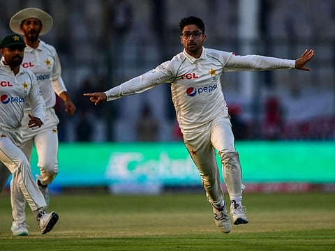 Pakistan's Abrar Ahmed (right) celebrates after taking wicket of England's Zak Crawley (not pictured) during the first day of the third cricket Test at the National Stadium in Karachi.