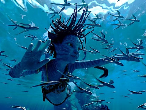 This image released by 20th Century Studios shows Trinity Bliss, as Tuk, in a scene from "Avatar: The Way of Water."