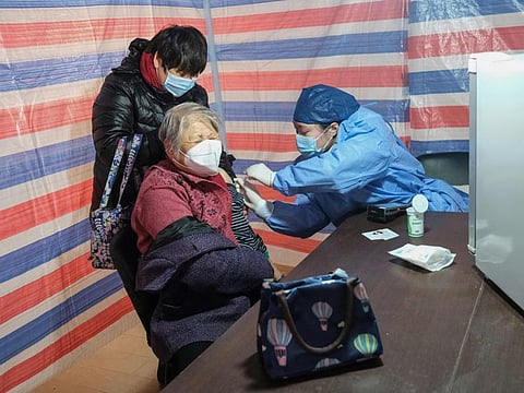 An elderly woman receives a vaccine in Shanghai on December 15, 2022.