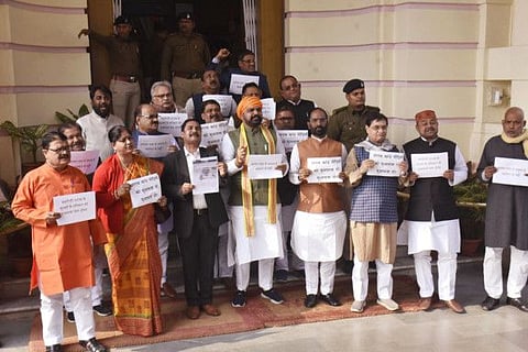 Bharatiya Janata Party (BJP) MLAs holding placards shout slogans during the protest outside the Bihar Legislative Assembly questioning liquor prohibition in the state in the wake of the Chhapra hooch tragedy during the Winter Session of the State Assembly, in Patna on Monday, December 19, 2022.