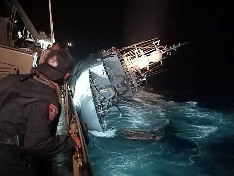 This handout photo taken on December 18, 2022 by the Royal Thai Navy shows the HTMS Sukhotha warship on its side before sinking in the Gulf of Thailand, off the coast of Bangsaphan district in Prachuab Kiri Khan province.