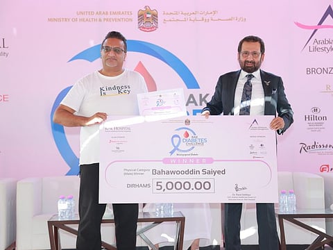 Winner of RAK Diabetes Challenge 2022 Bahawddin Saiyed receiving his prize from Dr Raza Siddiqui after a three-month-long competition.