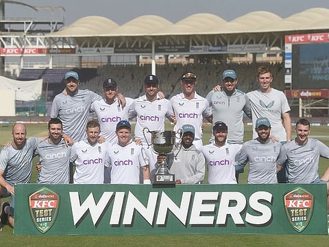 England's cricketers pose with the trophy after winning the Test series at the end of fourth day of third Test match against Pakistan at the National Stadium in Karachi on December 20, 2022.