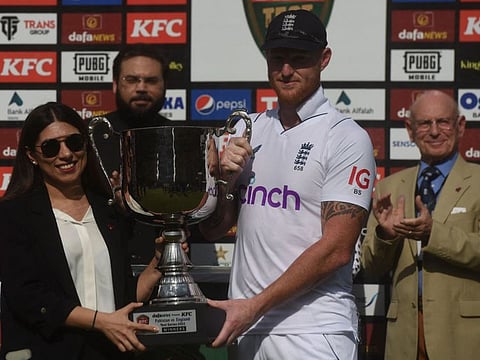 England's captain Ben Stokes receives the winning trophy during the prize presentation ceremony at the National Stadium in Karachi on Tuesday.