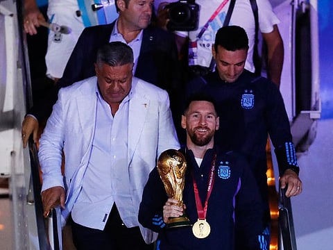 Claudio Tapia, president of the Argentine Football Association and Lionel Messi with the trophy during the team's arrival at Ezeiza International Airport.