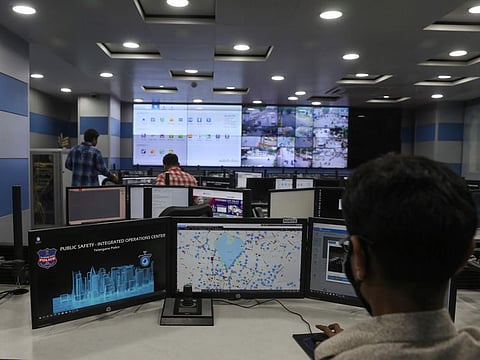 Employees work in the Command and Control Center at the Hyderabad Police Headquarters in Hyderabad, India, Thursday, April 21, 2022.