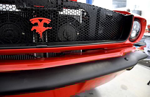 The front grille of an electrified 1965 Ford Mustang is seen at Inspire EV's garage in Arvada, Colo..A small but expanding group of tinkerers, racers, engineers, and entrepreneurs across the country are converting vintage cars and trucks into greener, often much faster, electric vehicles.
