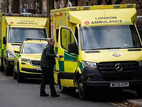 A paramedic shuts the door of an ambulance outside the Waterloo ambulance station in London on December 21, 2022.