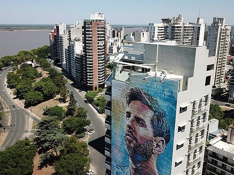 A Lionel Messi mural covers a building near the Paraná river in Rosario, Argentina, Wednesday, Dec. 14, 2022.