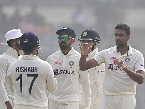 India’s Ravichandran Ashwin (R) celebrates with teammates after taking the wicket of Bangladesh's Nazmul Hasan Santo during the first day of the second Test at the Sher-e-Bangla National Cricket Stadium in Dhaka on December 22, 2022.