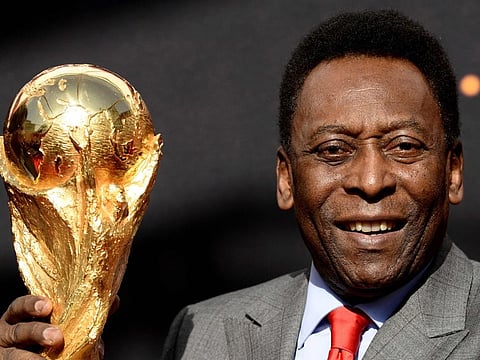 Pele poses with the FIFA World Cup trophy during a press conference in 2014. The Brazilian legend requires greater care related to renal and cardiac dysfunctions.