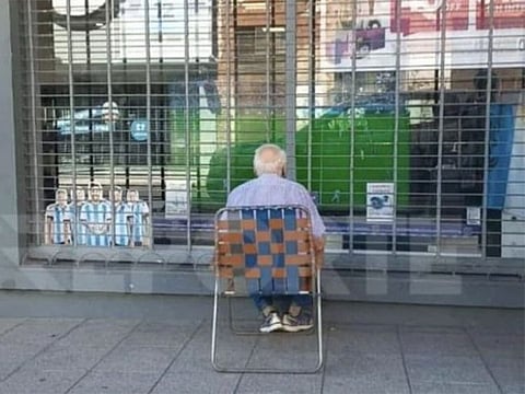 This photo of 83-year-old Argentina fan watching World Cup final through shop window went viral last week.