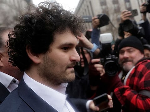 Former FTX chief executive Sam Bankman-Fried, who faces fraud charges over the collapse of the bankrupt cryptocurrency exchange, walks from the Manhattan federal court after securing bail in New York City.