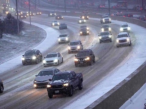 Commuters navigate a snow-covered Kennedy Expressway during a lighter-than-usual evening rush hour as temperatures hang in the single-digits in Chicago, Illinois.