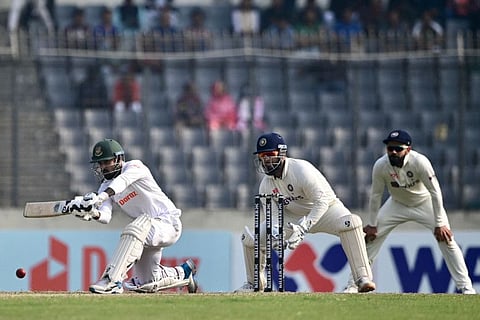 Bangladesh's Litton Das (left) plays a shot as India's wicketkeeper Rishabh Pant (centre) looks on during the third day of the second cricket Test at the Sher-e-Bangla National Cricket Stadium in Dhaka.