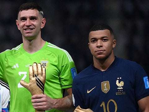 Emiliano Martinez (left) with Kylian Mbappe.
