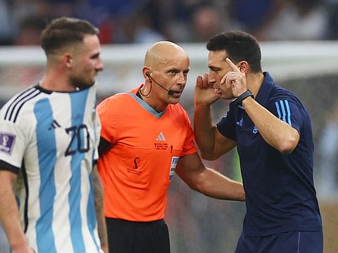 Argentina coach Lionel Scaloni (right) speaks to referee Szymon Marciniak (centre) during the World Cup final against France at Lusail Stadium, Qatar.