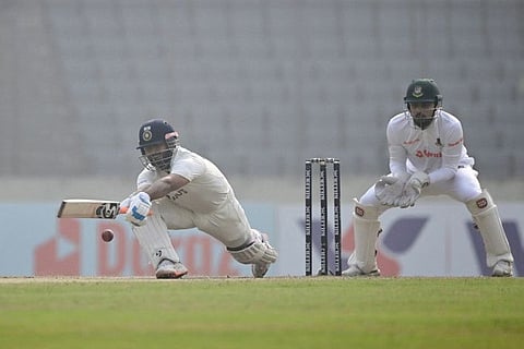 Indias Rishabh Pant (left) plays a shot as Bangladeshs Nurul Hasan (right) looks on during the fourth day of the second cricket Test at the Sher-e-Bangla National Cricket Stadium in Dhaka. India won by 3 wickets.