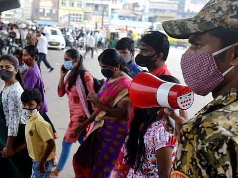 A Bruhat Bengaluru Mahanagara Palike (BBMP) marshal asking people wear face masks, take COVID-19 vaccine, and follow COVID-appropriate behaviour in Bengaluru on Sunday..