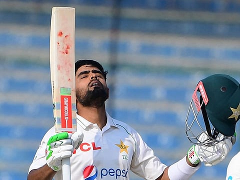 Pakistan's captain Babar Azam gestures after scoring a century during the first day of the first Test against New Zealand at the National Stadium in Karachi.