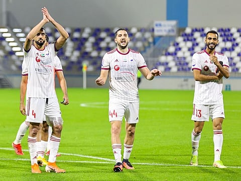 Sharjah FC players celebrate their 2-0 victory over Dibba at full time.